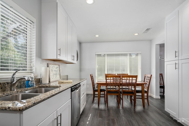 kitchen with dark wood-style floors, a sink, white cabinets, and dishwasher