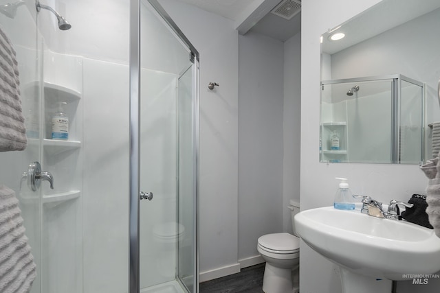 bathroom with a stall shower, visible vents, and toilet