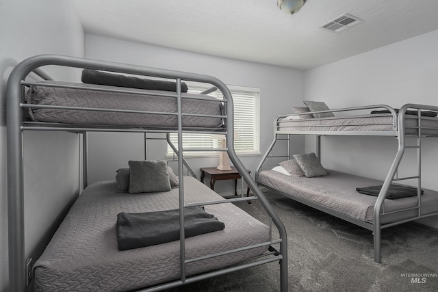 bedroom with visible vents and carpet