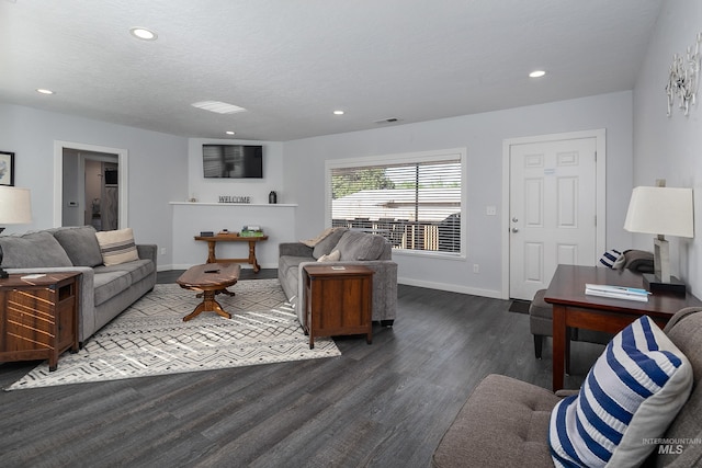 living area featuring recessed lighting, baseboards, a textured ceiling, visible vents, and wood finished floors