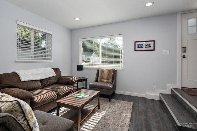 living room with recessed lighting, dark wood-style floors, baseboards, and a wealth of natural light