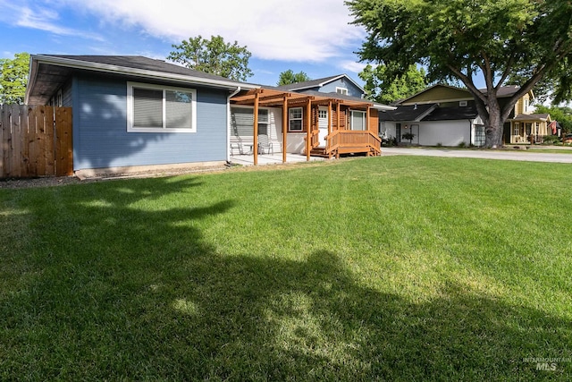 single story home with fence and a front lawn