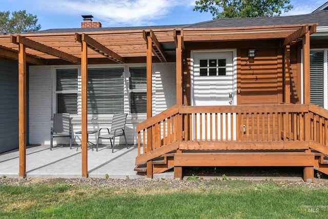 deck with a pergola and a patio