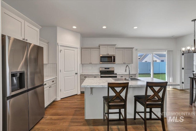 1275 Terra Ave, Twin Falls, ID 83301 - kitchen featuring appliances with stainless steel finishes, light countertops, tasteful backsplash, an island with sink, and recessed lighting