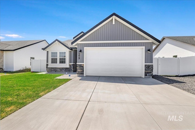 1275 Terra Ave, Twin Falls, ID 83301 - view of front of home with stone siding, a garage, driveway, and board and batten siding