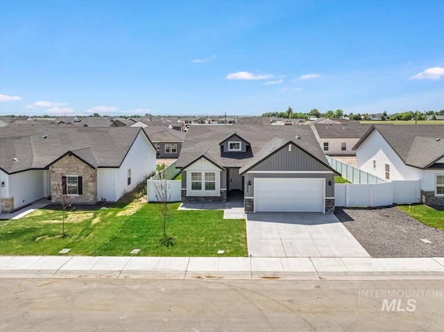 1275 Terra Ave, Twin Falls, ID 83301 - view of front of home with board and batten siding, stone siding, an attached garage, concrete driveway, and a residential view