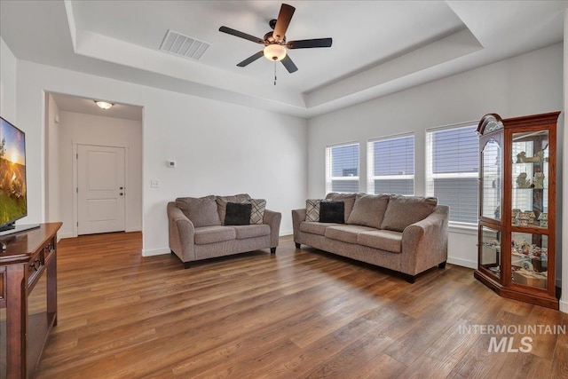 1275 Terra Ave, Twin Falls, ID 83301 - living room with a raised ceiling, wood finished floors, and ceiling fan