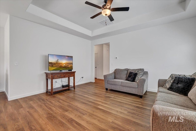 1275 Terra Ave, Twin Falls, ID 83301 - living area with a tray ceiling, wood finished floors, and ceiling fan