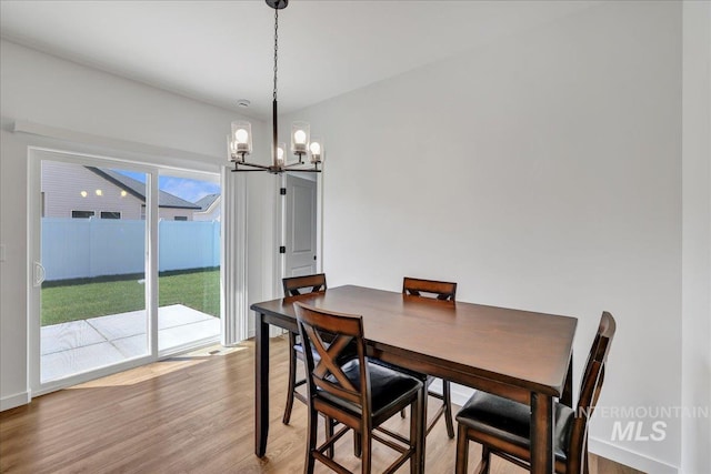 1275 Terra Ave, Twin Falls, ID 83301 - dining area featuring a chandelier and light wood-style flooring