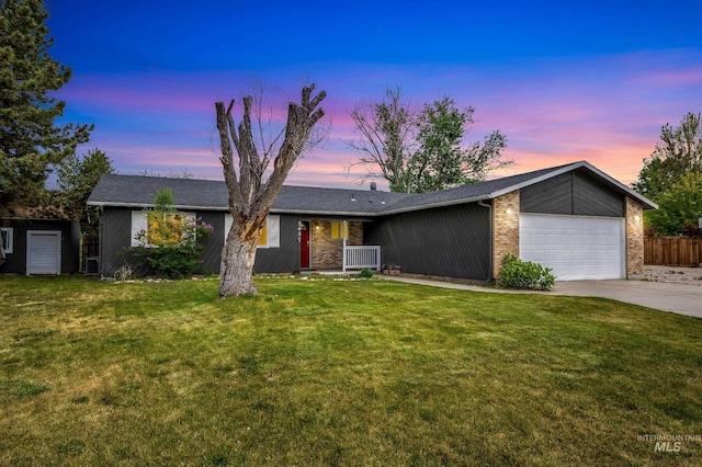5457 S Oseola Pl, Boise, ID 83709 - mid-century home featuring a garage, driveway, and brick siding