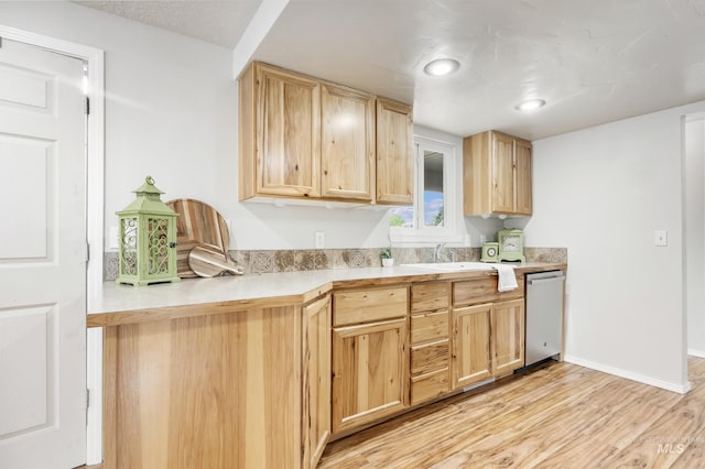 5457 S Oseola Pl, Boise, ID 83709 - kitchen featuring dishwasher, light brown cabinets, light wood-style floors, a sink, and light countertops