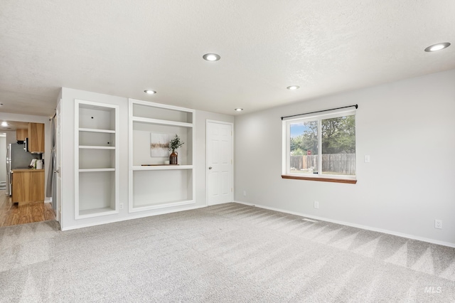 5457 S Oseola Pl, Boise, ID 83709 - empty room featuring carpet, baseboards, recessed lighting, a textured ceiling, and built in features
