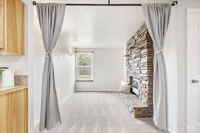 5457 S Oseola Pl, Boise, ID 83709 - unfurnished living room featuring carpet flooring, baseboards, a stone fireplace, and a textured ceiling