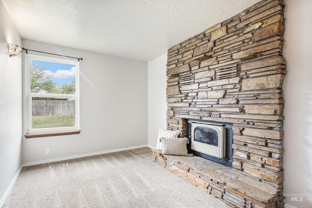 5457 S Oseola Pl, Boise, ID 83709 - unfurnished living room with a textured ceiling, carpet flooring, a wood stove, and baseboards