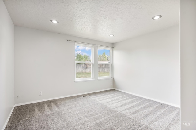 5457 S Oseola Pl, Boise, ID 83709 - carpeted spare room featuring a textured ceiling, baseboards, and recessed lighting