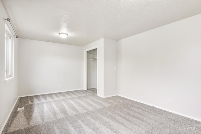 5457 S Oseola Pl, Boise, ID 83709 - unfurnished bedroom featuring a textured ceiling, carpet, baseboards, and a closet