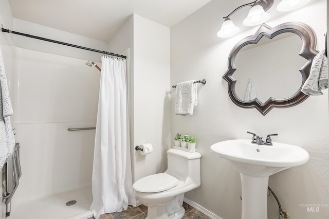 5457 S Oseola Pl, Boise, ID 83709 - bathroom featuring a stall shower, toilet, and tile patterned floors