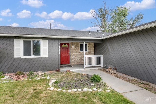 5457 S Oseola Pl, Boise, ID 83709 - view of exterior entry with brick siding and a shingled roof