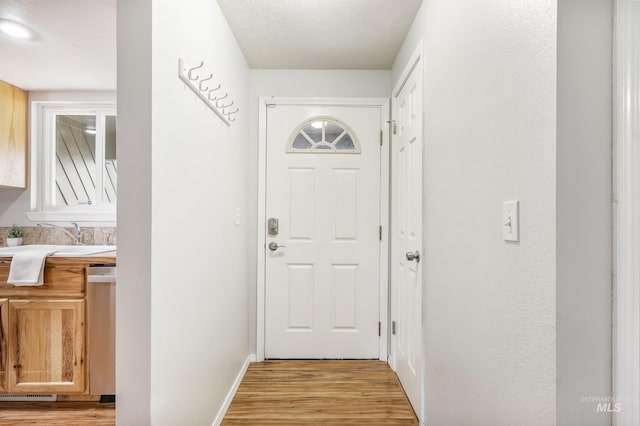 5457 S Oseola Pl, Boise, ID 83709 - doorway featuring light wood-style flooring and baseboards