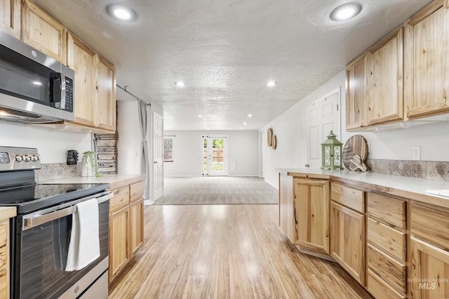 5457 S Oseola Pl, Boise, ID 83709 - kitchen with appliances with stainless steel finishes, light brown cabinets, light countertops, and recessed lighting
