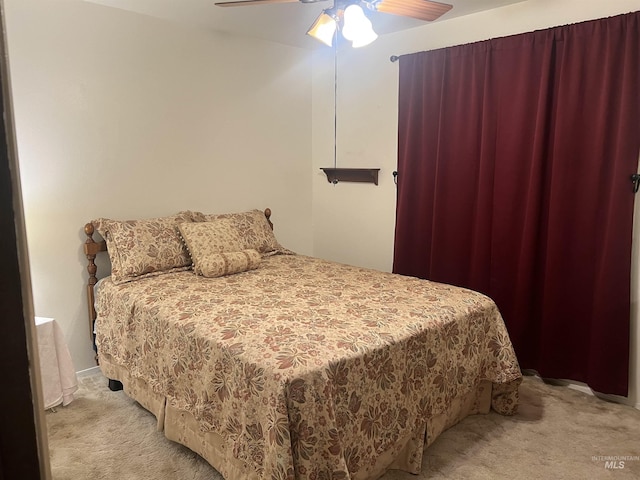 bedroom with light carpet and ceiling fan