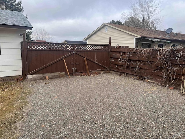 view of gate featuring fence