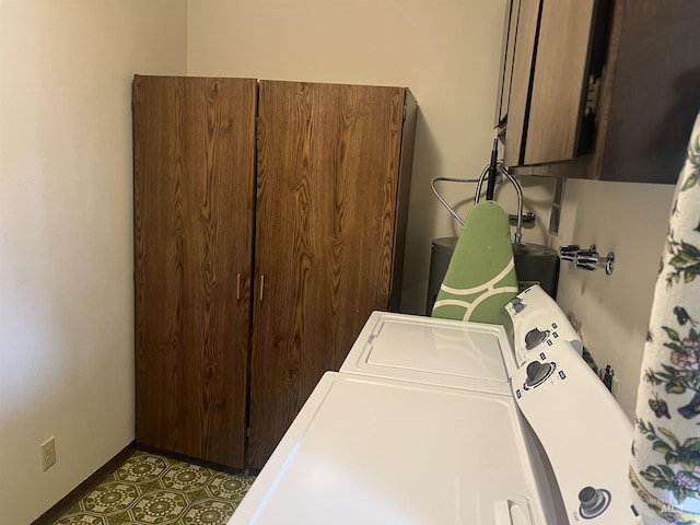 laundry room with washer and dryer, cabinet space, and baseboards