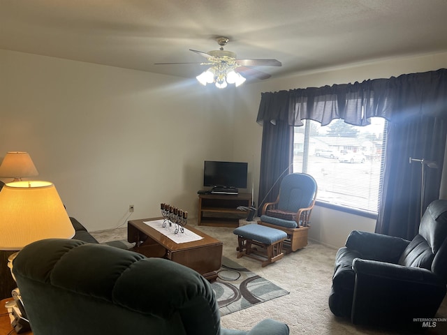 carpeted living room featuring ceiling fan