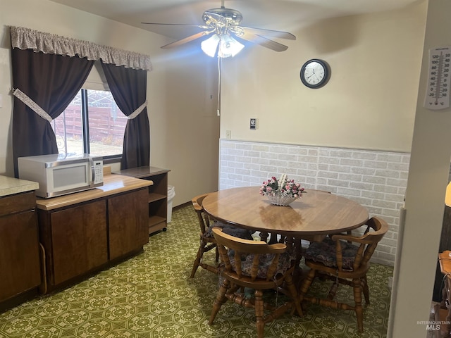 dining room featuring ceiling fan