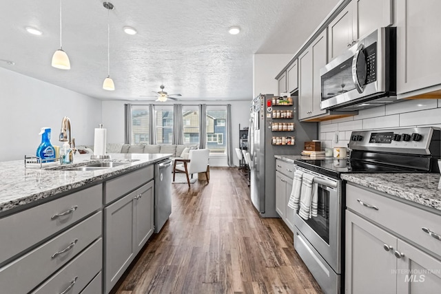 3084 N Network Ln, Boise, ID 83704 - kitchen featuring stainless steel appliances, gray cabinets, dark wood-style floors, a textured ceiling, and a ceiling fan