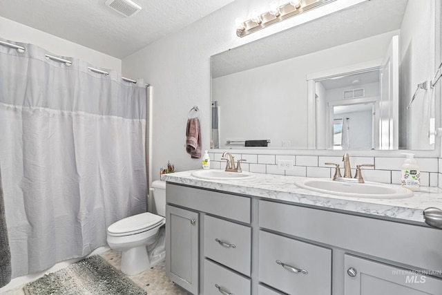 3084 N Network Ln, Boise, ID 83704 - bathroom featuring double vanity, backsplash, a shower with curtain, tile patterned flooring, and a textured ceiling