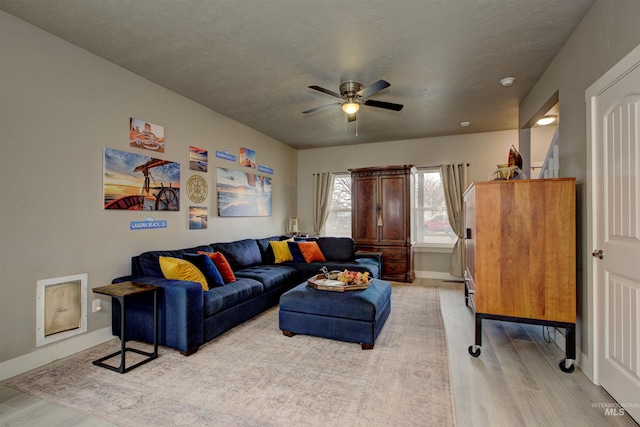 living room featuring ceiling fan and light wood-type flooring