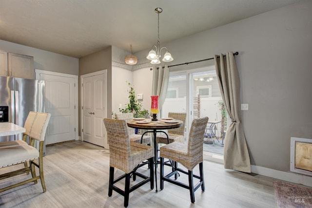 dining room featuring a chandelier and light wood-type flooring