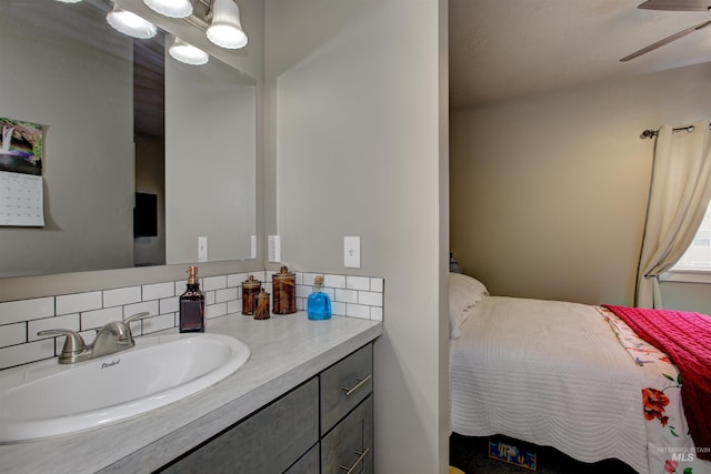 bathroom featuring ceiling fan, vanity, and decorative backsplash