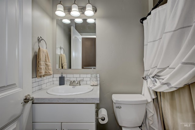 bathroom with tasteful backsplash, vanity, and toilet