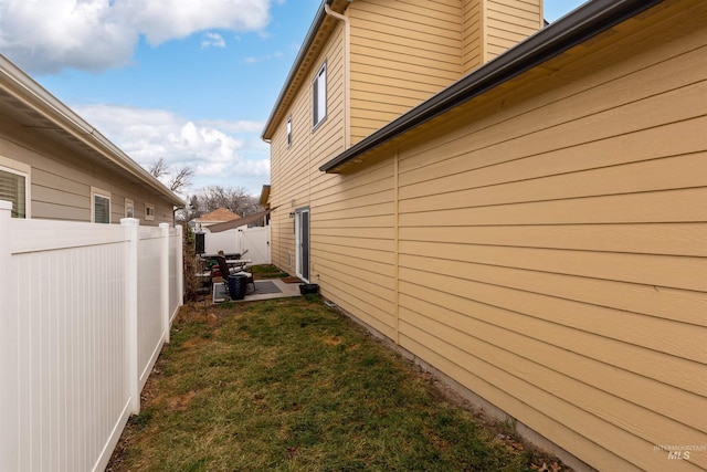 view of side of home with a yard