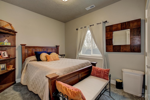 bedroom featuring a textured ceiling and carpet flooring