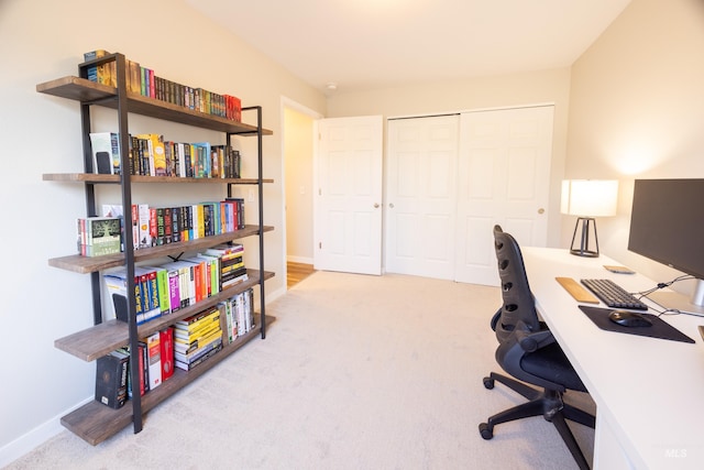 office area featuring baseboards and carpet