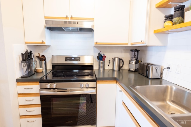 kitchen featuring a sink, decorative backsplash, stainless steel electric range oven, white cabinets, and under cabinet range hood