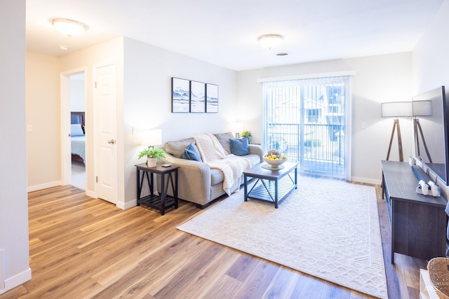 living area with wood finished floors and baseboards