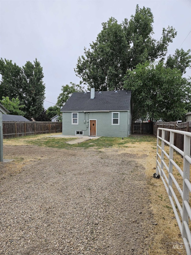 407 E Freeport St, Caldwell, ID 83605 - rear view of property featuring a fenced backyard and a chimney