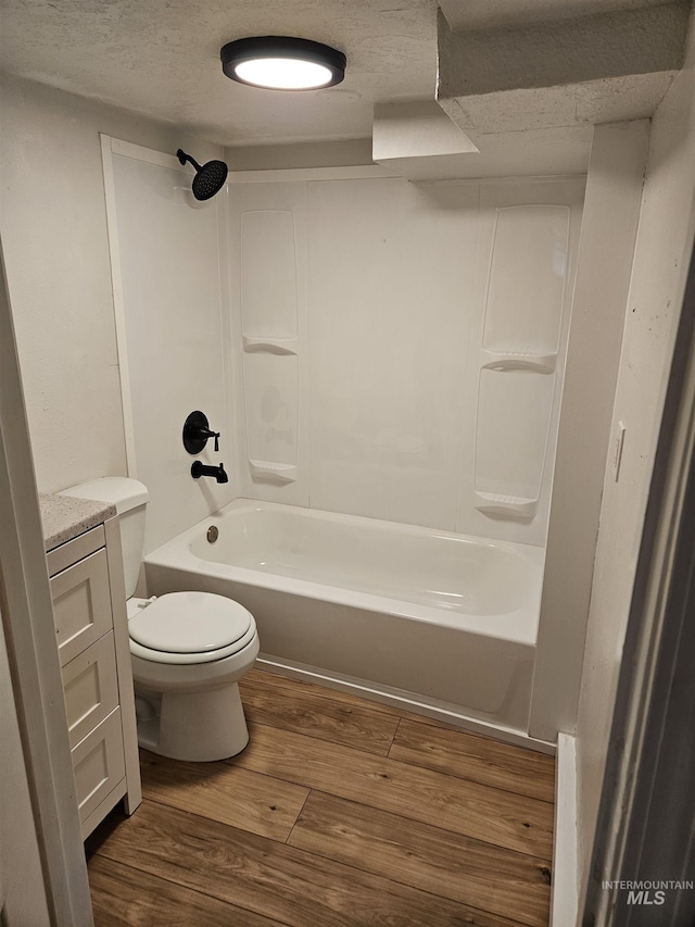 407 E Freeport St, Caldwell, ID 83605 - full bath featuring wood finished floors, bathtub / shower combination, vanity, and a textured ceiling