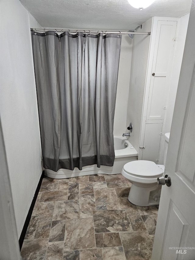 407 E Freeport St, Caldwell, ID 83605 - bathroom featuring shower / bath combination with curtain, stone finish floors, and a textured ceiling