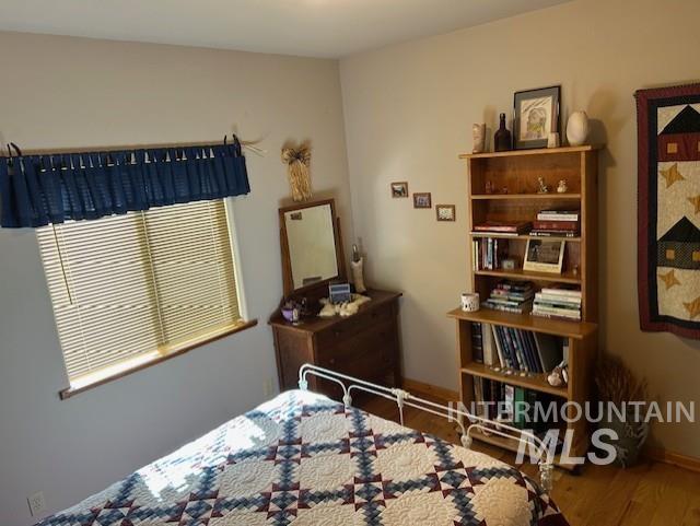 1621 Doumecq Rd, Cottonwood, ID 83522 - bedroom featuring wood finished floors and baseboards
