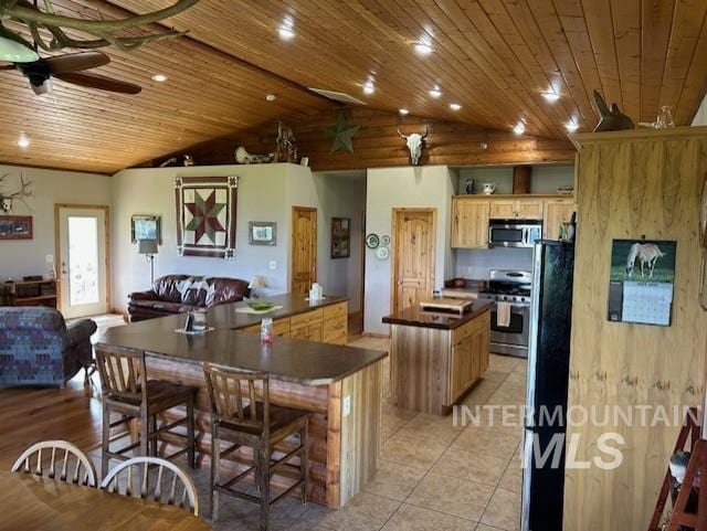 1621 Doumecq Rd, Cottonwood, ID 83522 - kitchen with stainless steel appliances, dark countertops, a spacious island, ceiling fan, and wooden ceiling