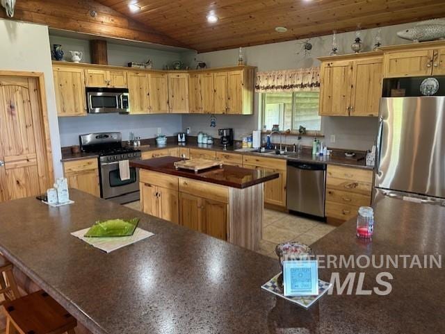 1621 Doumecq Rd, Cottonwood, ID 83522 - kitchen featuring appliances with stainless steel finishes, a kitchen island, light brown cabinetry, wooden ceiling, and lofted ceiling