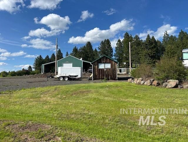 1621 Doumecq Rd, Cottonwood, ID 83522 - view of grassy yard with a detached garage and an outbuilding