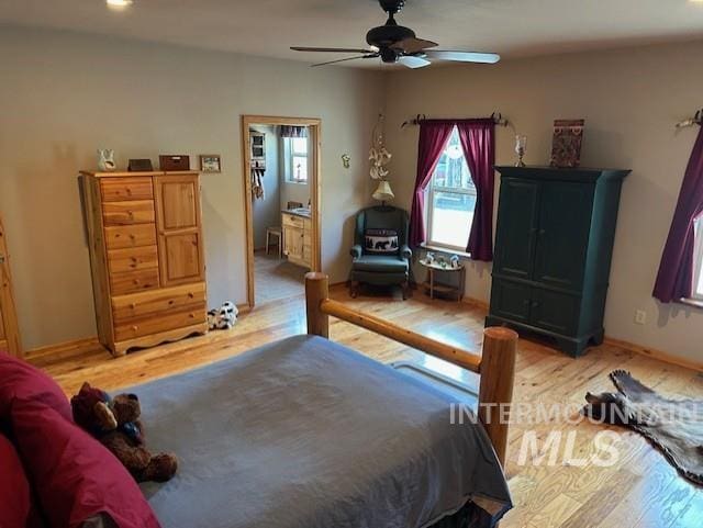 1621 Doumecq Rd, Cottonwood, ID 83522 - bedroom with light wood-type flooring, connected bathroom, ceiling fan, and baseboards