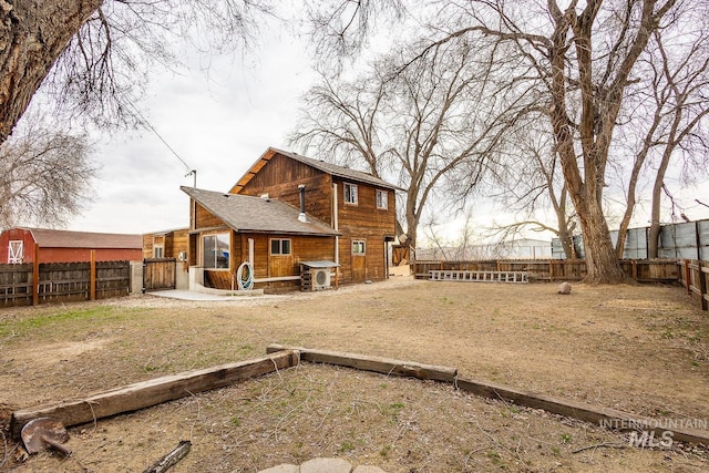 rear view of property with a fenced backyard