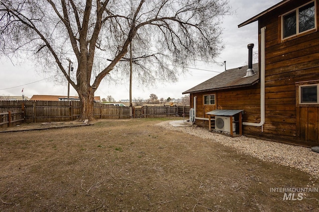 view of yard with a fenced backyard and ac unit